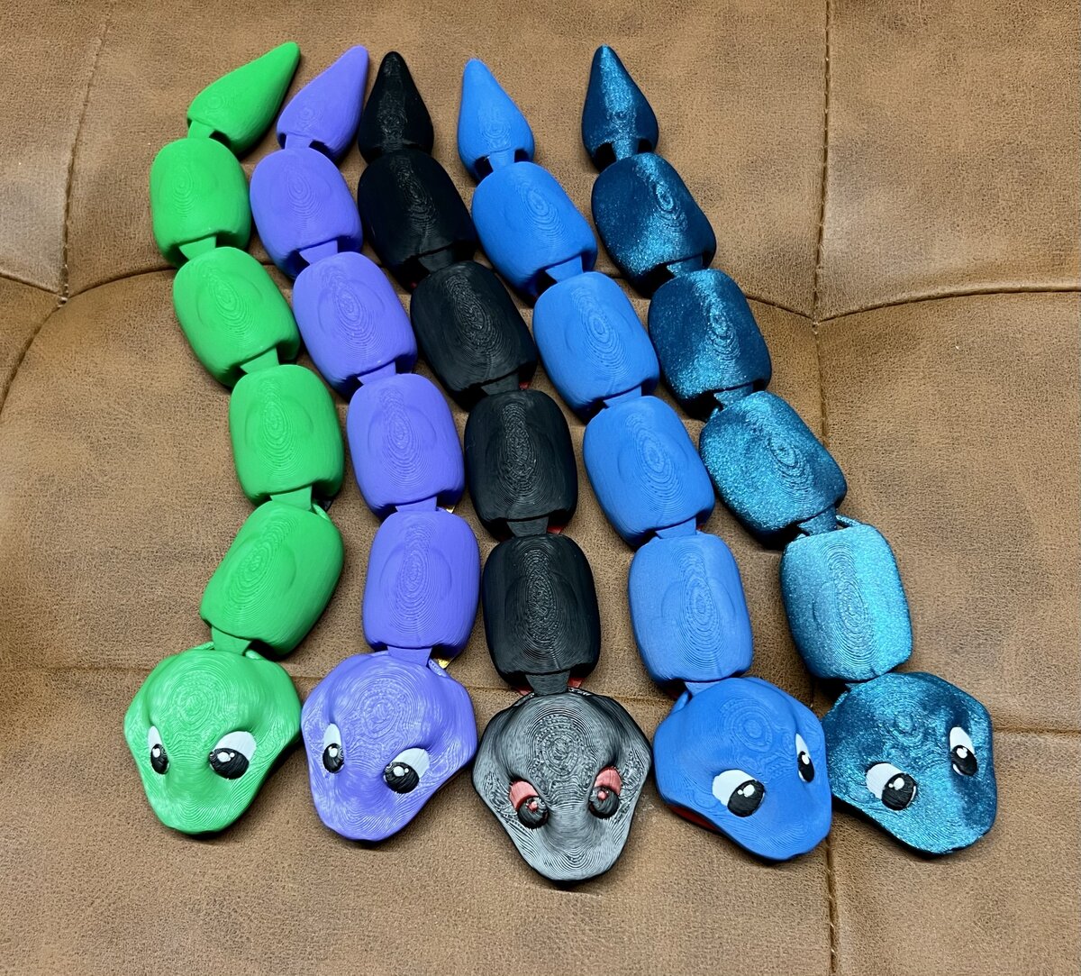 Five segmented snake toys with cute painted eyes